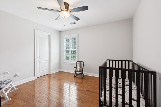 Versatile third bedroom upstairs with hardwood floors and plantation shutters. | Image 30