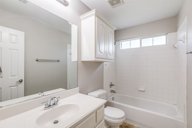 Full bath with visible vents, toilet, vanity, and shower combination | Image 18