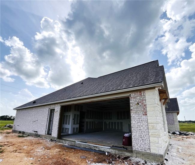 View of side of home with roof with shingles and brick siding | Image 12