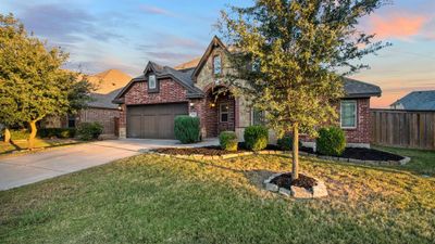 View of front of home with a garage and a lawn | Image 2