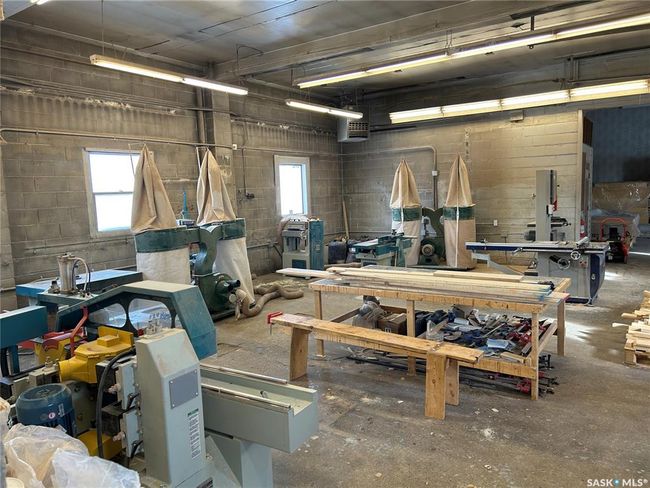 Miscellaneous room with a workshop area, plenty of natural light, and concrete block wall | Image 22