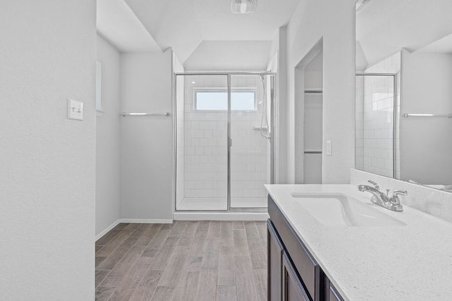 Full bathroom featuring a shower stall, vanity, and wood finished floors | Image 22