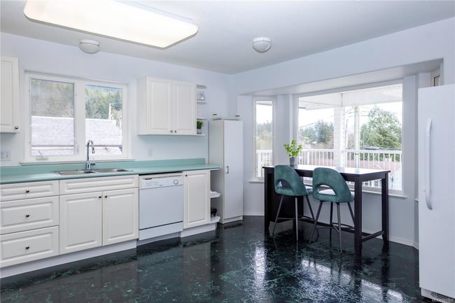Kitchen with bay window, 2 sky lights and sliders to the covered deck | Image 5