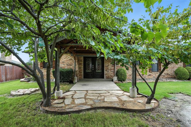 View of exterior entry with french doors and brick siding | Image 24