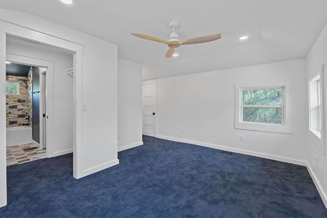 Unfurnished bedroom with dark carpet, recessed lighting, and ceiling fan | Image 13