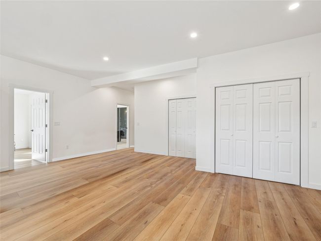 Open floor plan living room with abundant closet space | Image 11