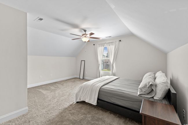 Carpeted bedroom with lofted ceiling, baseboards, and ceiling fan | Image 21
