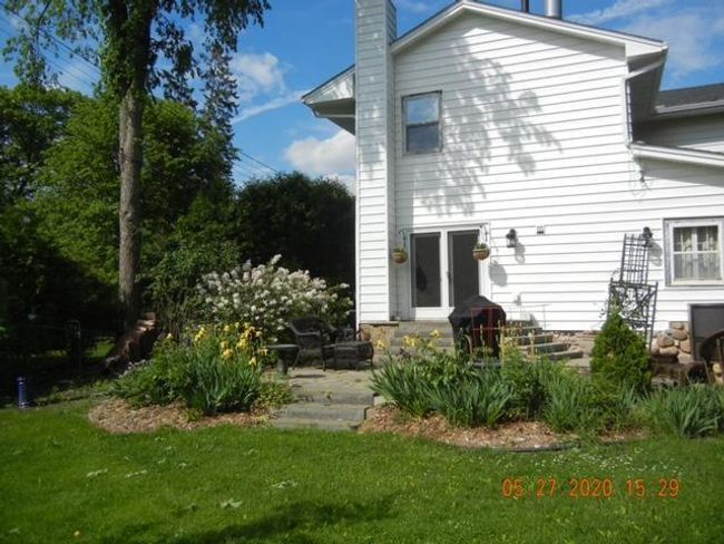 Beautiful plantings surround front yard patio | Image 53