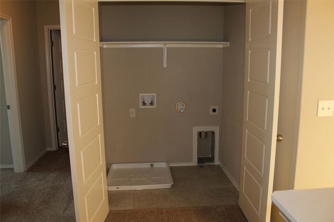 Laundry area featuring hookup for an electric dryer, hookup for a washing machine, hookup for a gas dryer, baseboards, and tile patterned flooring | Image 12