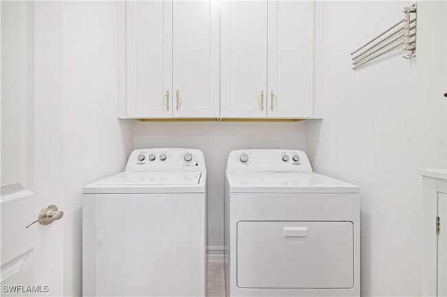 Washroom with washer and clothes dryer and cabinet space | Image 23
