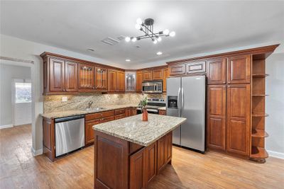 Granite counters and stainless steel appliances round off this updated kitchen! | Image 3