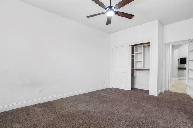 Unfurnished bedroom with carpet flooring, a closet, baseboards, and ceiling fan | Image 31