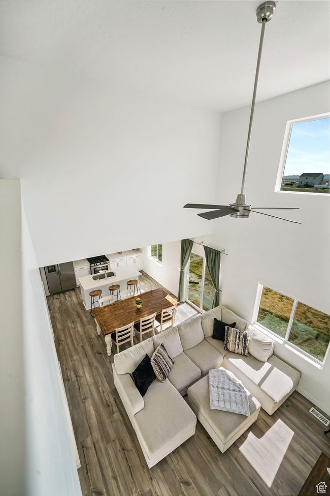 Living area featuring wood finished floors and ceiling fan | Image 28