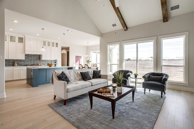 Living room with a healthy amount of sunlight, beam ceiling, and light wood-type flooring | Image 11