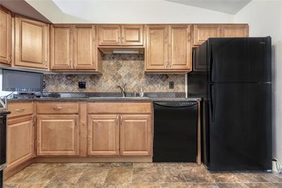 A good view of the beautiful tile backsplash and ceramic tile floooring in the kitchen. | Image 3