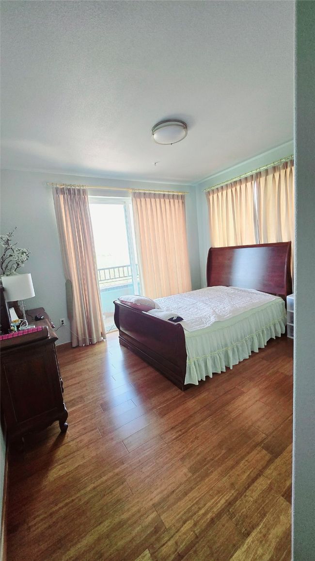 Bedroom featuring wood finished floors, access to outside, and a textured ceiling | Image 5