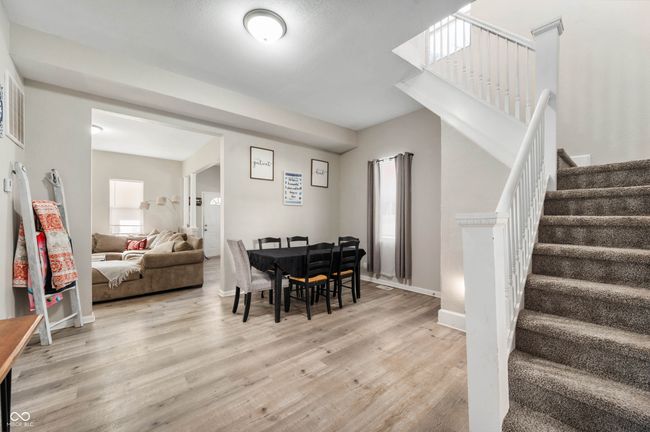 dining space featuring baseboards, light wood-style floors, and stairs | Image 7