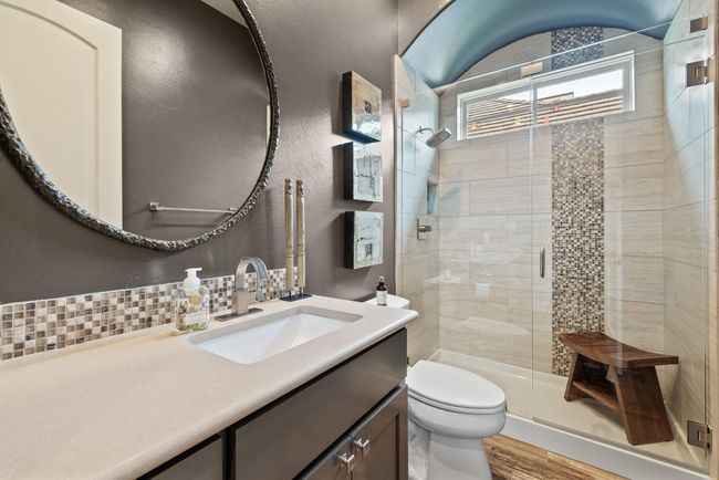 Full bath with toilet, vanity, a stall shower, wood finished floors, and decorative backsplash | Image 22