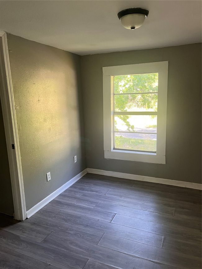Spare room featuring baseboards and dark wood-type flooring | Image 20