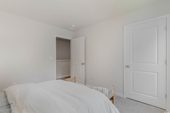 Bedroom with light carpet and baseboards | Image 26