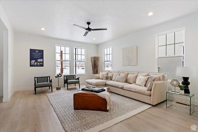 Living room with light hardwood / wood-style floors and ceiling fan | Image 3