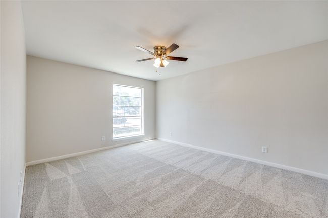 Spare room with ceiling fan and light colored carpet | Image 21