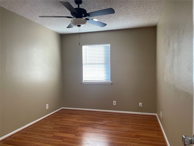 Empty room featuring a textured ceiling, ceiling fan, and hardwood / wood-style floors | Image 25