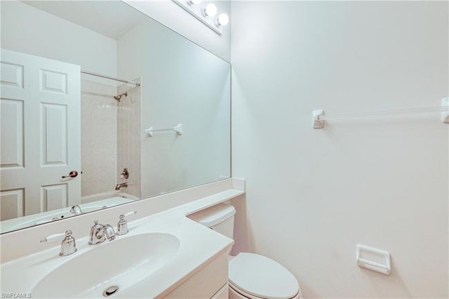 Full bathroom with vanity, tiled shower / bath combo, and toilet | Image 15