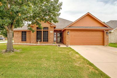 Single story home with a garage and a front yard | Image 2