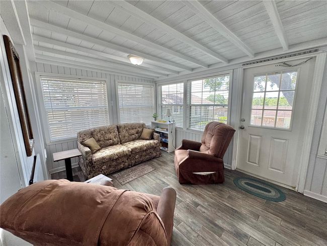 Front Florida room with a pull out couch for sleeping and chairs for sitting area and table/chairs eating area. Can be closed off for privacy. | Image 24
