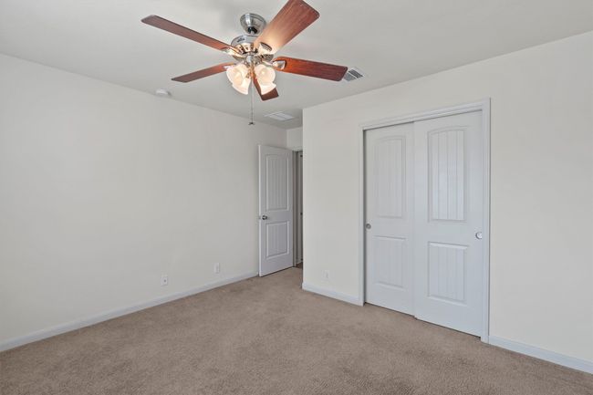 Bedroom 1 -- closet and ceiling fan | Image 16
