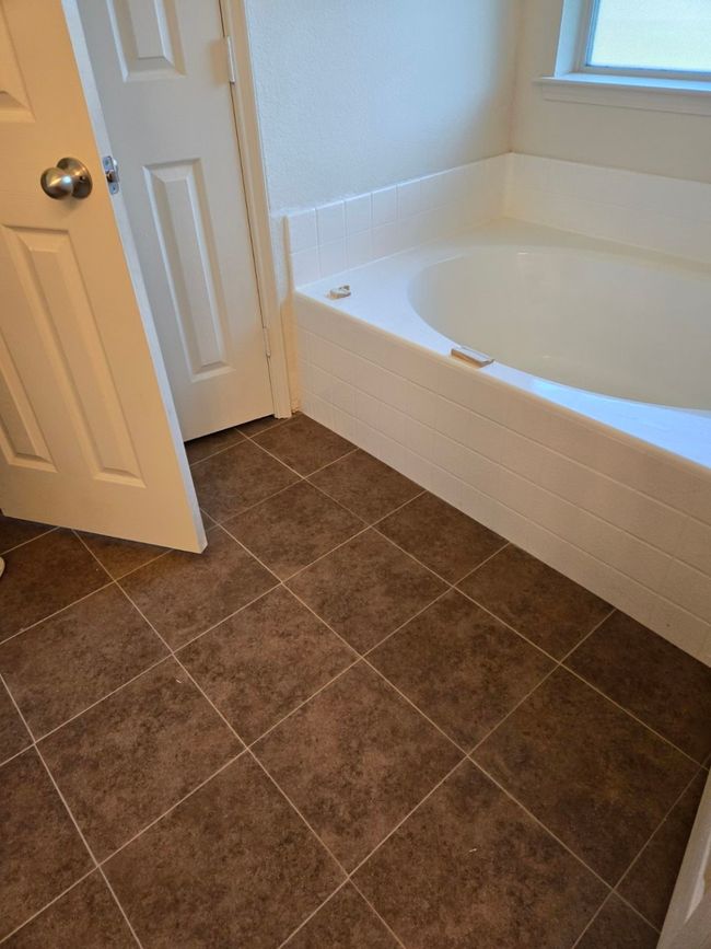 Full bath with a garden tub and tile patterned floors | Image 30