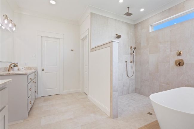 Bathroom with vanity, walk in shower, a freestanding bath, and recessed lighting | Image 18