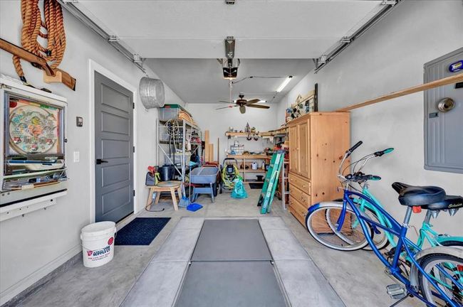 Garage with a ceiling fan and a garage door opener | Image 35