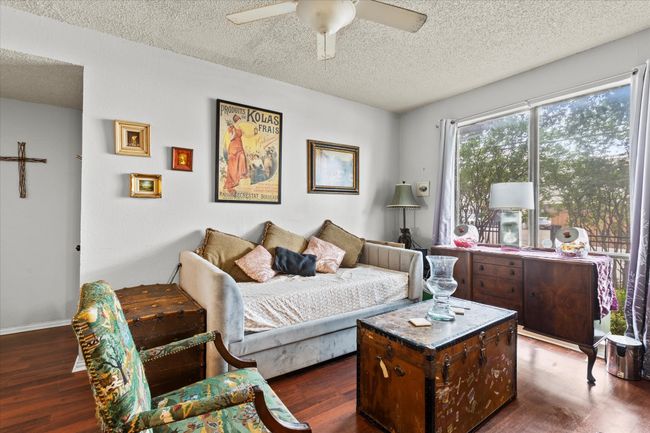 Bedroom with a textured ceiling, a ceiling fan, and dark wood-style floors | Image 4