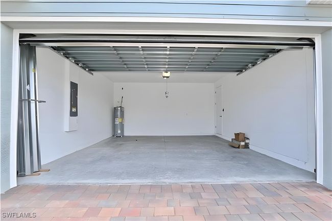 Garage featuring water heater and electric panel | Image 19