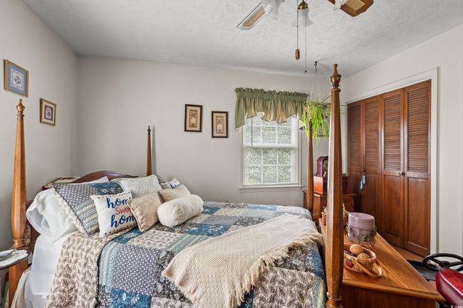 Bedroom featuring a textured ceiling, a closet, and ceiling fan | Image 17