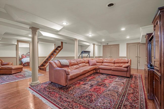 Basement with decorative columns and light hardwood / wood-style flooring | Image 20