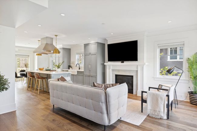 Living room featuring recessed lighting, light wood-style floors, a premium fireplace, crown molding, and baseboards | Image 9