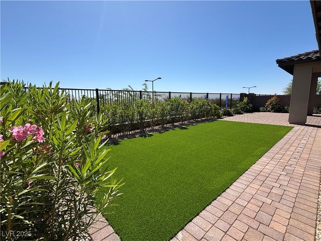 View of yard with fence and a patio area | Image 40