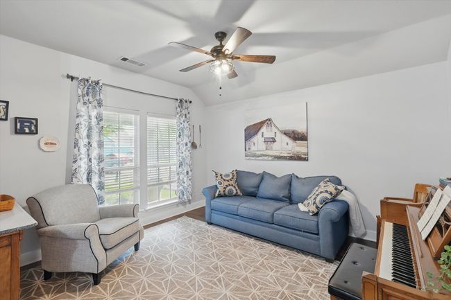 Living area with ceiling fan and vaulted ceiling | Image 7