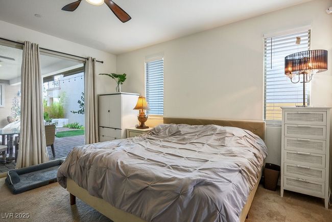 Carpeted bedroom featuring access to exterior, multiple windows, and ceiling fan | Image 21