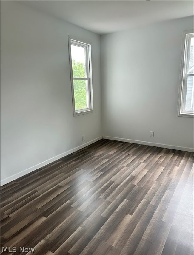 Spare room featuring dark hardwood / wood-style floors | Image 10