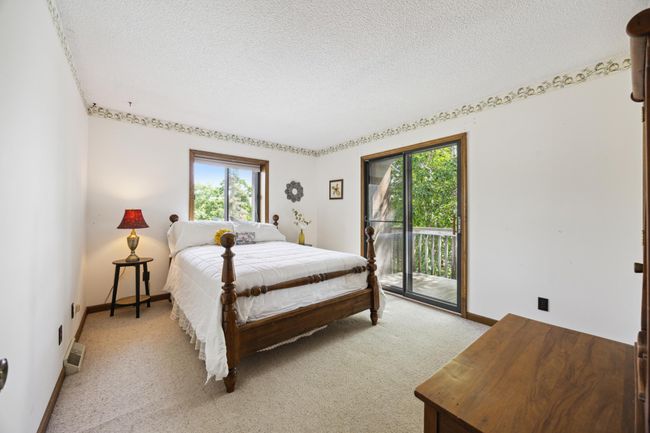 Second bedroom upstairs with another balcony and patio door. Overlooking the lake. | Image 16