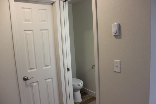 Bathroom with toilet and wood finished floors | Image 11