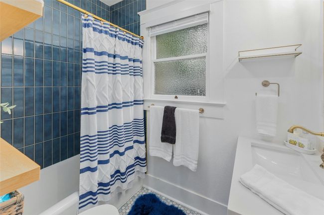 Shared bathroom with updated penny tile floors. | Image 9