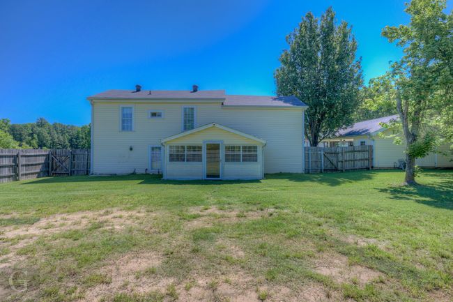 Back of house with a gate and a sunroom | Image 25