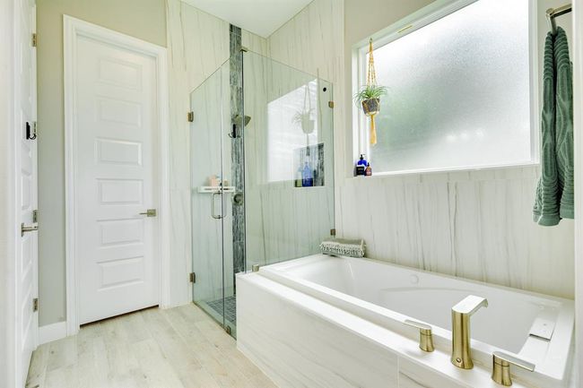 The primary bathroom features dual sinks, walk-in shower, and separate tub. | Image 24