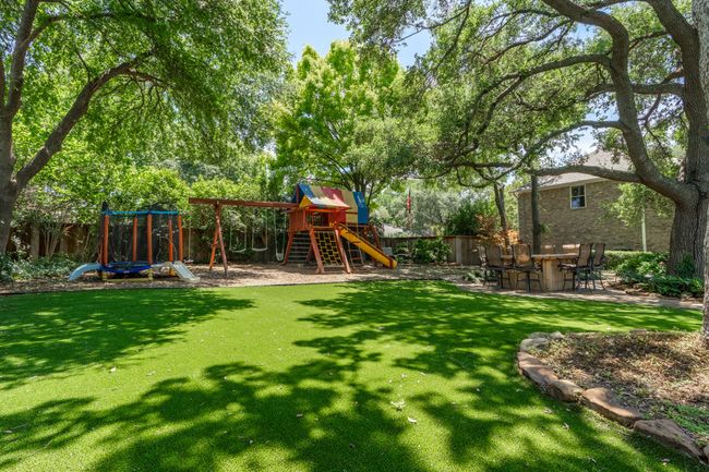 Backyard featuring a playground area & playscape. Pet-astroturf | Image 35