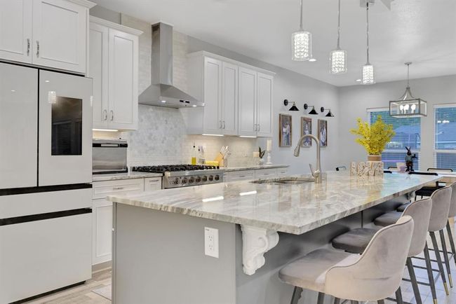 Elegant kitchen with premium appliances and a spacious island, ideal for family gatherings. | Image 18